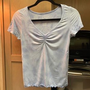 V neckline, blue shortsleeved shirt.